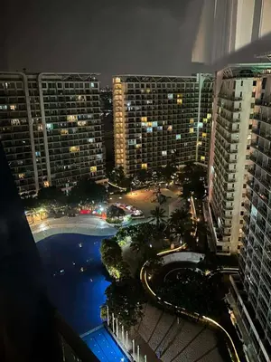 a view of a city at night with buildings at staycation at azure - near airport in Manila