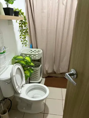 a bathroom with a toilet with a shower curtain at Casa Verde Suite - Staycation