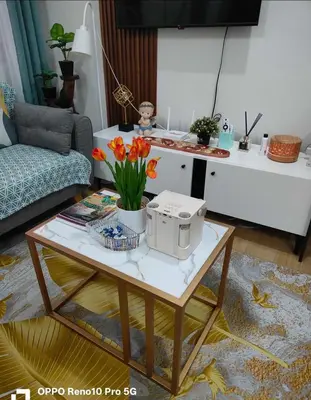 a living room with a coffee table with flowers on it at Casa Verde Suite - Staycation