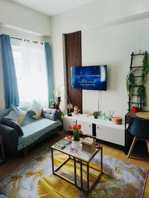 a living room with a couch and a tv at Casa Verde Suite - Staycation