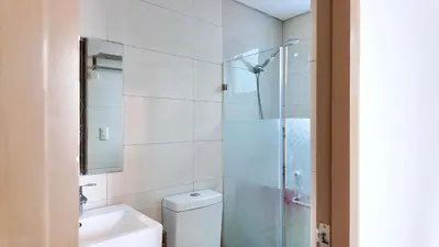 a bathroom with a shower and a toilet and a sink at Spacious Family Room Near NAIA Airport in Manila