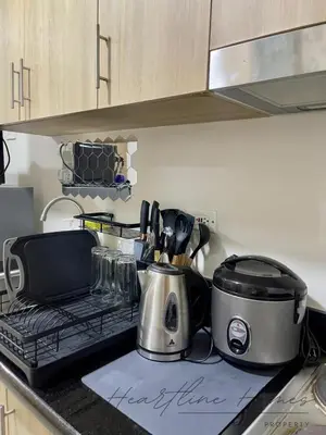 a kitchen counter with a slow cooker and a toaster at Heartline Homes Shore 2 Residences in Manila