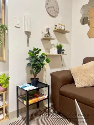a living room with a couch and a table with a plant at Heartline Homes Shore 2 Residences in Manila