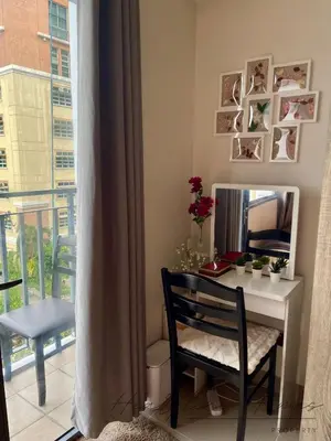 a room with a desk with a mirror and a chair at Heartline Homes Shore 2 Residences in Manila