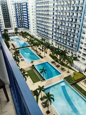 a view of the pool from the balcony of a building at Luxx Place in Manila
