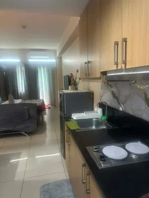 a kitchen with a sink and a stove in it at Queen Magzy Place in Manila