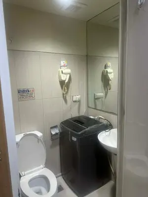 a small bathroom with a toilet and a sink at Queen Magzy Place in Manila