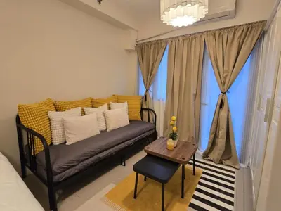 a living room with a couch and a table at Cozy Modern Studio Near MOA Brand New Furnishings in Manila