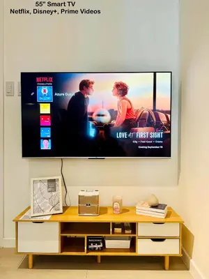 a flat screen tv hanging on a wall at Deluxe penthouse unit at azure - near airport in Manila