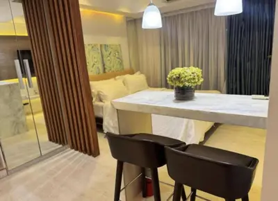 a living room with a table and two chairs at Family room at azure - near airport in Manila