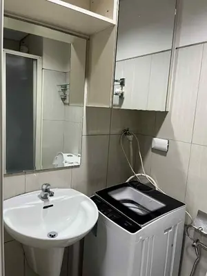 a bathroom with a sink and a mirror at shell residences -RJ in Manila