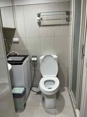 a small bathroom with a toilet and a sink at shell residences -RJ in Manila