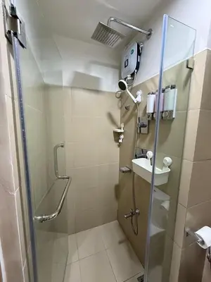 a bathroom with a shower and a sink at Condotel 1BR w balcony at MOA SMDC Shore3 T1 in Manila