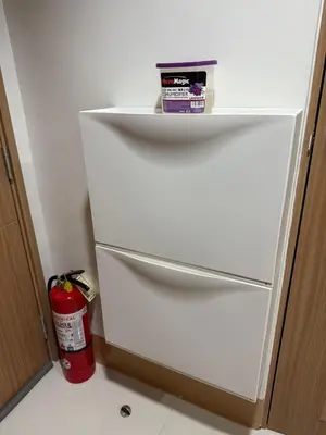 a white refrigerator with a fire extinguisher in a kitchen at Condotel 1BR w balcony at MOA SMDC Shore3 T1 in Manila