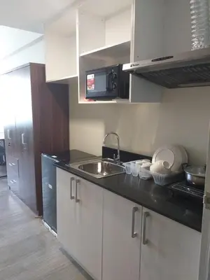 a kitchen with a sink and a counter top at MetroStay Studio Legarda in Manila
