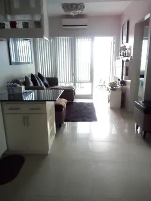 a living room with a couch and a table at Condotel Sea Residence's Place Near Moa in Manila