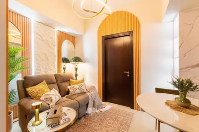 a living room with a couch and a table at Cozy Modern Organic 1BR with Washer and WiFi Near BGC in Manila