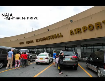 a group of people standing outside of a parking lot at Luxurious Homey Suite IN FRONT of US Embassy Manila Bay in Manila