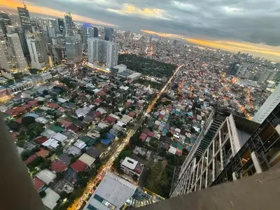 an aerial view of a city at night at 1 BR Loft type in Manila