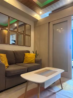 a living room with a couch and a coffee table at Jazz Residences Condominium in Manila