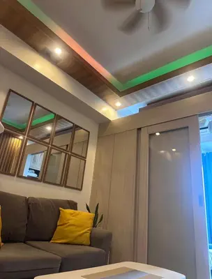 a living room with a couch and a window at Jazz Residences Condominium in Manila