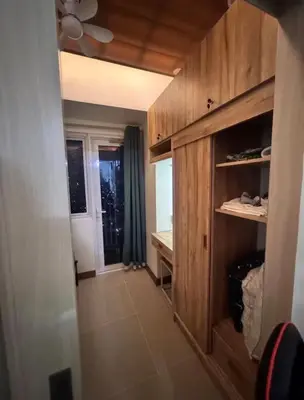 a hallway of a house with a room with a window at Jazz Residences Condominium in Manila