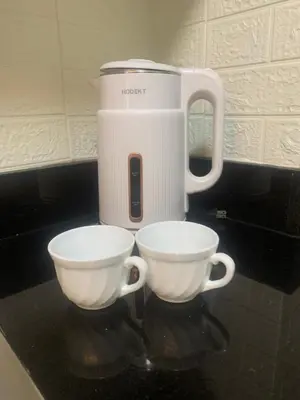 two cups sitting on top of a counter with a appliance at Shore Residences by Buhay Staycation in Manila