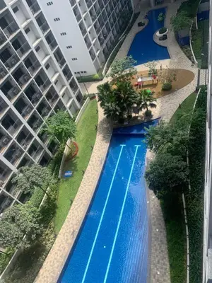 an overhead view of a swimming pool next to a tall building at Shore Residences by Buhay Staycation in Manila