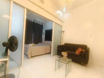 a living room with a couch and a bedroom at STUDIO Type CONDO in Manila