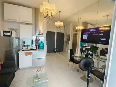 a kitchen and living room with a table and chairs at STUDIO Type CONDO in Manila