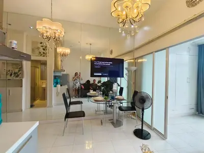 a dining room with a table and chairs and a tv at STUDIO Type CONDO in Manila