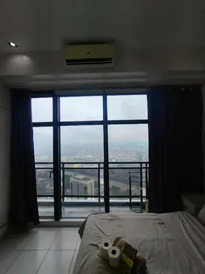 a bedroom with a bed and a large window at STUDIO Type CONDO in Manila