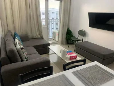 a living room with a couch and a table at Shore Residence by Buhay Staycation in Manila