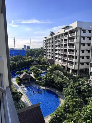arial view of a resort with a pool and buildings at Alea Residences 1 Bedroom Condo with Pool View Balcony in Manila