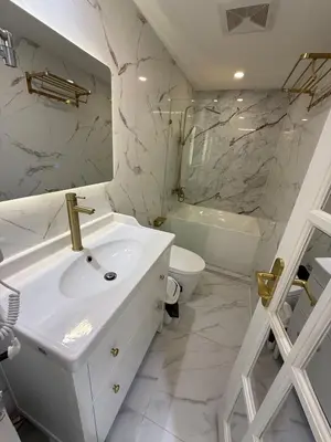 a white bathroom with a sink and a toilet at Azure 2BR Beach View Suite- Bathtub, Smart Toilet, Netflix in Manila