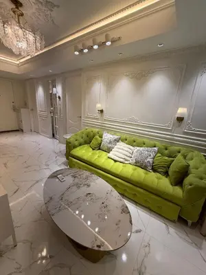 a living room with a green couch and a table at Azure 2BR Beach View Suite- Bathtub, Smart Toilet, Netflix in Manila