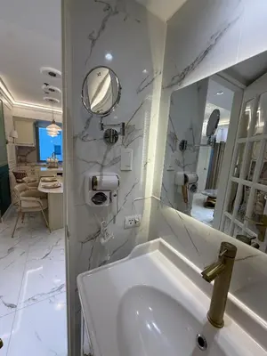 a white bathroom with a sink and a mirror at Azure 2BR Beach View Suite- Bathtub, Smart Toilet, Netflix in Manila