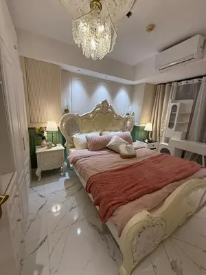 a bedroom with a large bed and a chandelier at Azure 2BR Beach View Suite- Bathtub, Smart Toilet, Netflix in Manila