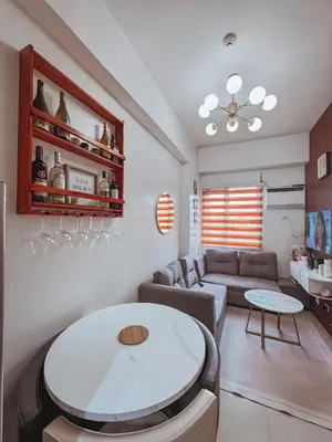 a living room with a couch and a table at FOG Staycation in Manila