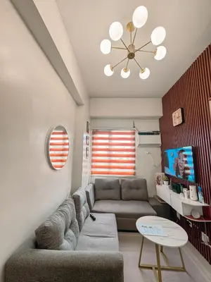 a living room with a couch and a table at FOG Staycation in Manila