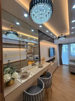 a dining room with a large mirror and chandeliers at Hotel-like flat at Bay City Haven Mall of Asia SMX in Manila