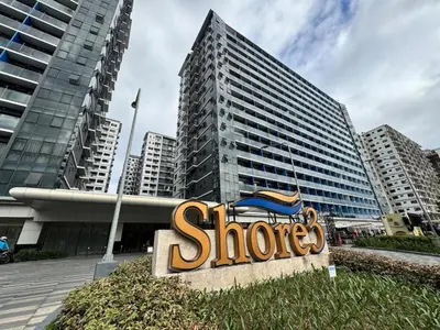 a sign for a store in front of some buildings at Hotel-like flat at Bay City Haven Mall of Asia SMX in Manila