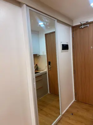 a sliding glass door in a room with a kitchen at Hotel-like flat at Bay City Haven Mall of Asia SMX in Manila