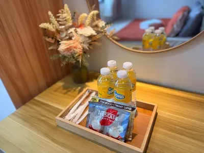a tray with bottles of drinks on a table in front of a mirror at Manila Flat Mall of Asia SMX city view with netflix in Manila