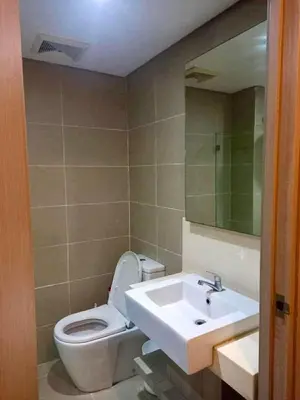 a bathroom with a sink and a toilet and a mirror at Studio in serenity - Peaceful and Calm ambiance in Manila