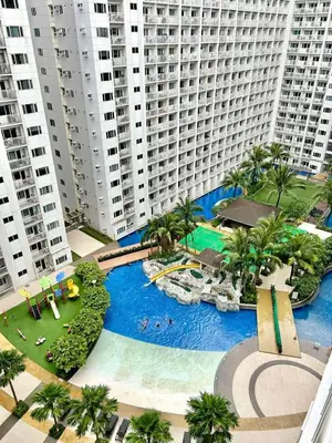 an aerial view of a large swimming pool with tall buildings at SHORE 1 MALL OF ASIA Staycation in Manila