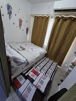 a small bed in a small room with curtains at SHORE 1 MALL OF ASIA Staycation in Manila