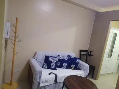 a living room with a couch and a table at SHORE 1 MALL OF ASIA Staycation in Manila