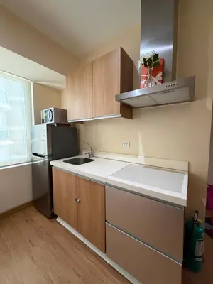 a small kitchen with a sink and a refrigerator at SYM staycation at Azure in Manila
