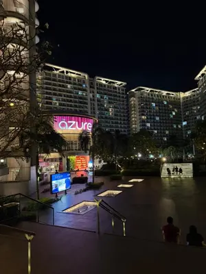 a night view of a large city with buildings at SYM staycation at Azure in Manila